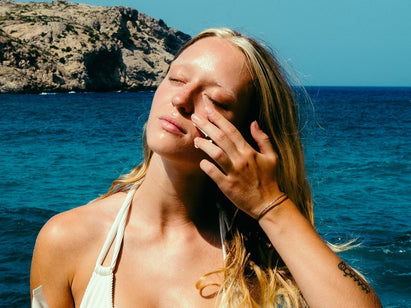 woman applying sunscreen to her face