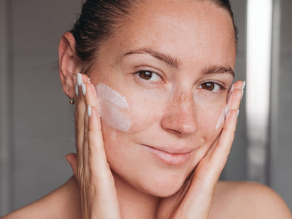 woman washing her face
