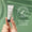 En hånd holder en tube Green People Firming Vitamin C Eye Serum 10ml mot en grønn bakgrunn med et dermatologisk testet-merke.