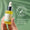 En hånd holder en dråpeflaske med Green People Anti-Aging Facial Oil mot en grønn bakgrunn med et dermatologisk testet-stempel.