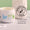 Åpen hvit krukke med Organic Babies Mum & Baby Rescue Balm står på en marmorflate ved siden av et dermatologisk testet-stempel.