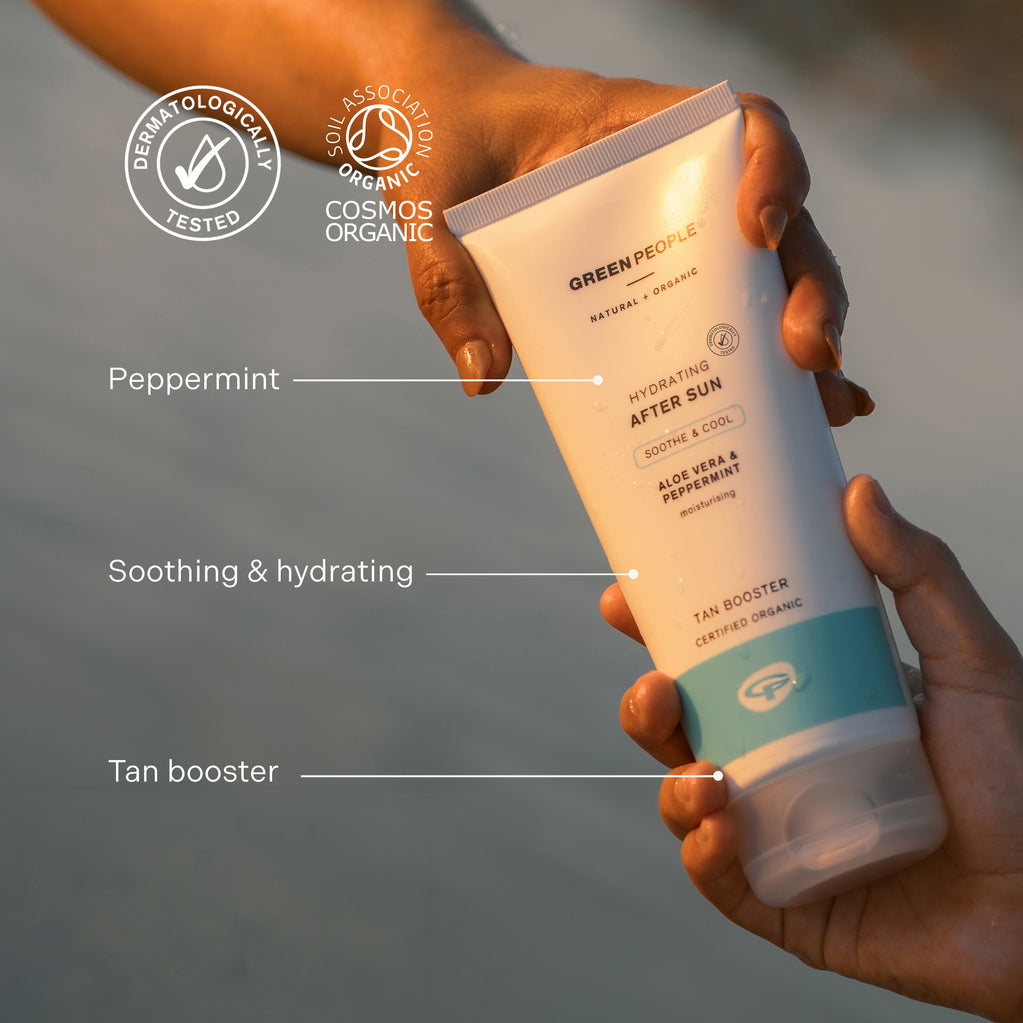 Hands hold a tube of Green People Hydrating After Sun cream highlighting natural ingredients and tan booster benefits.