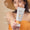A woman in a sun hat holds a tube of Scent Free Sun Cream SPF30 200ml with text pointing out its fragrance-free, organic formula.