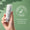 En hånd holder Green People Scent Free ansikts- og halsserum mot grønn bakgrunn med «Dermatologically Tested»-logo.