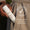 En hånd holder en flaske Green People Scent Free Light Moisturiser i en beigefarget jakkelomme.