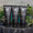 Tre svarte Green People for Men-tuber, inkludert No. 1 Exfoliating Face Scrub, plassert på et brett med grønne blader bak.