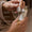 Hands use a glass dropper to apply golden Age Defy+ Collagen Boost Face Oil Elixir onto skin.