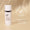En hvit flaske Age Defy+ Brightening Moisturiser står på en nøytral beigefarget bakgrunn ved siden av et dermatologisk testet-segl.